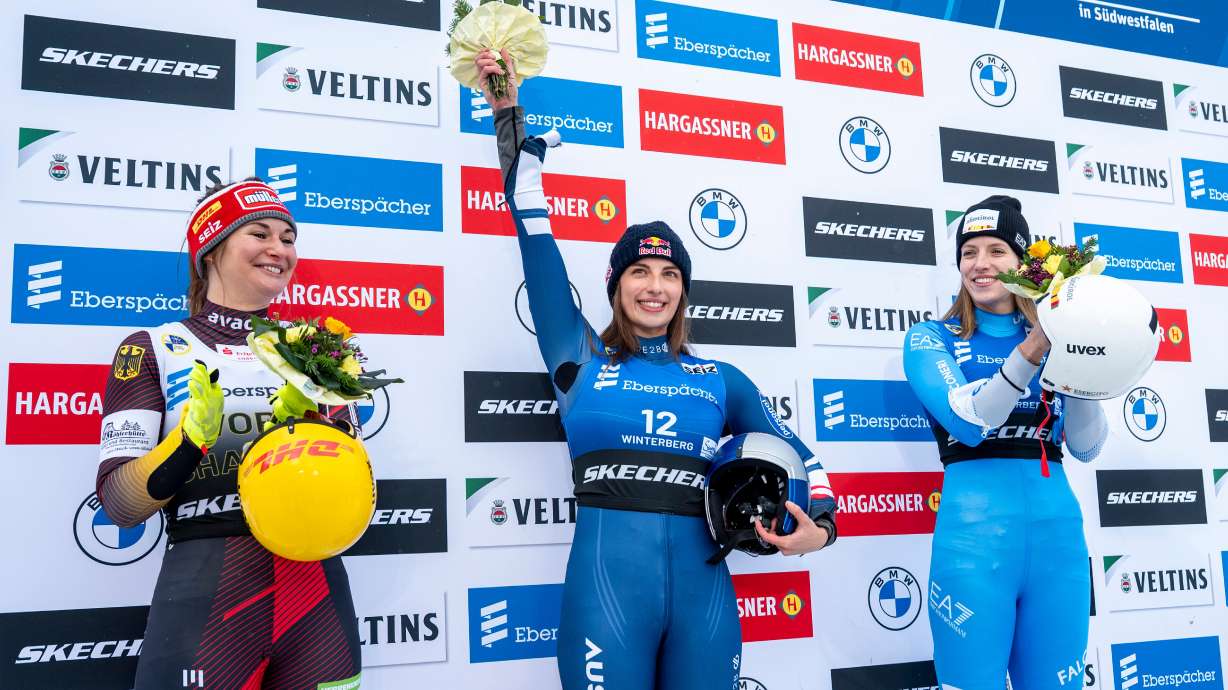 Runner-up Julia Taubitz, of Germany, from left, winner Hannah Prock, of Austria, and third-placed Verena Hofer, of Italy, celebrate on the podium following the Luge Women World Cup, single-seater, 2nd run in Winterberg, Germany, Saturday, Jan. 10, 2026.