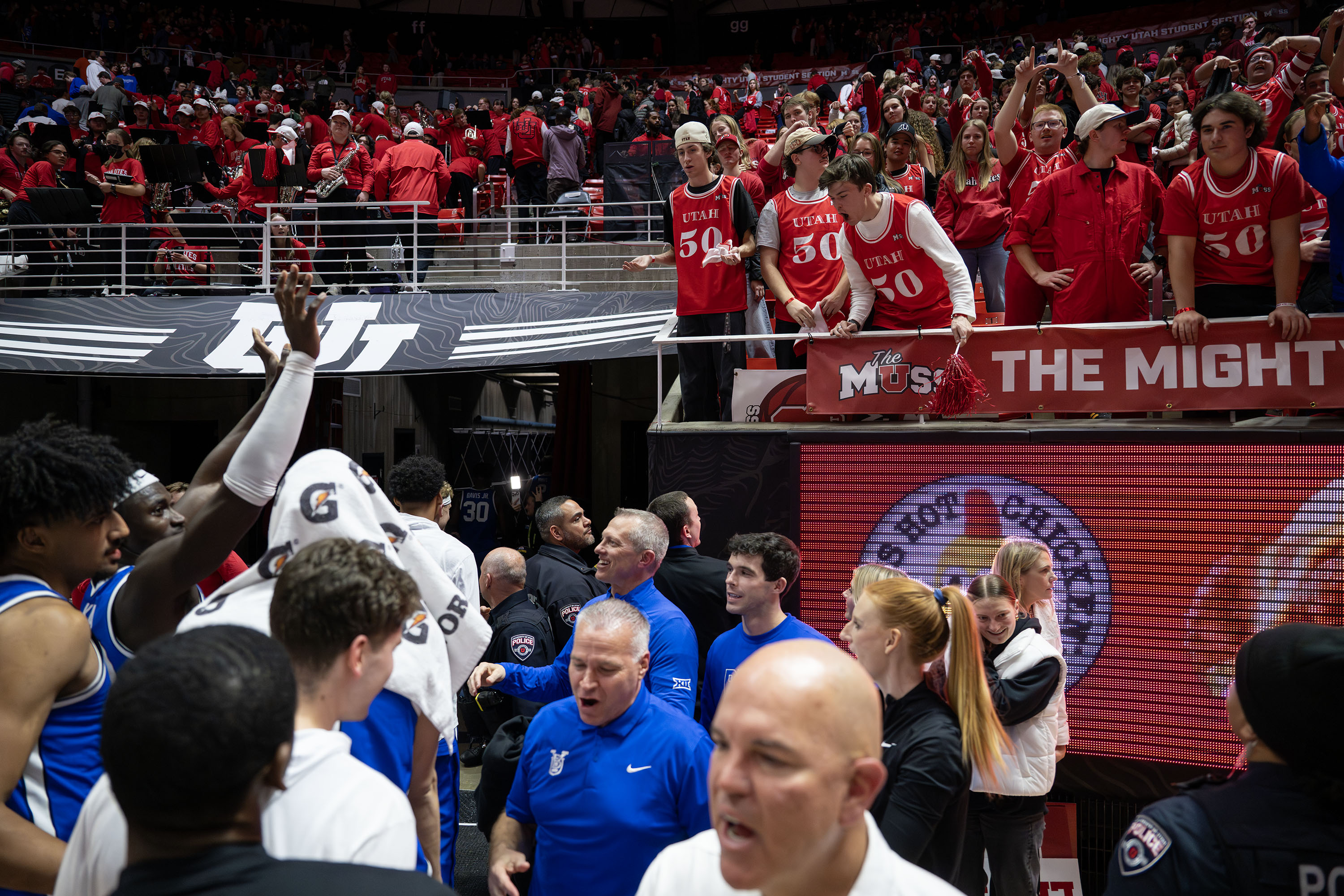 Utah Utes fans and BYU Cougars players gesture and jaw back and forth as the Cougars exit the arena after defeating Utah 89-84 at the Huntsman Center in Salt Lake City on Saturday, Jan. 10, 2026.
