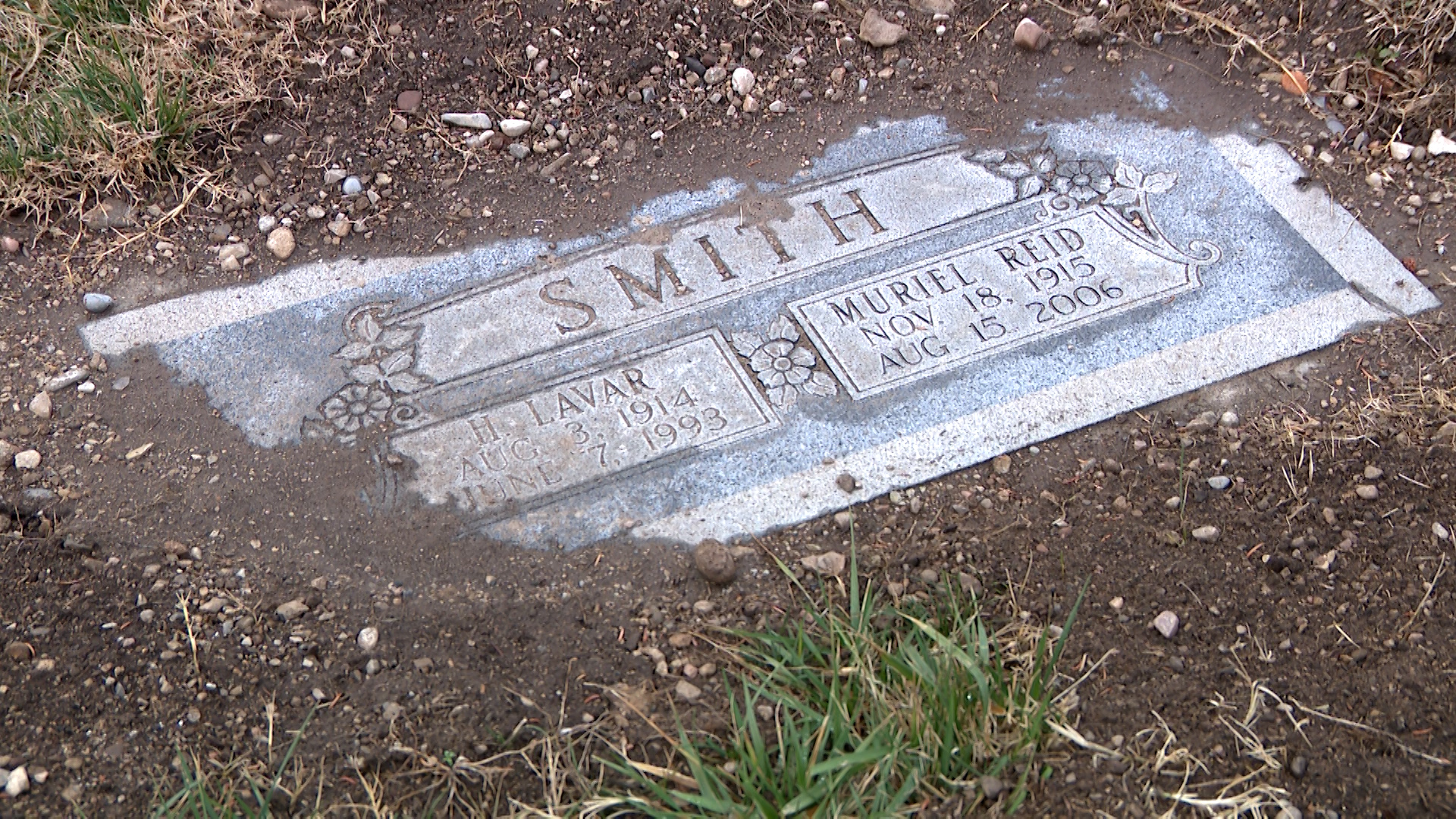 Several headstones at the Salt Lake Cemetery are shown visibly sunken, tilted or covered by displaced soil.