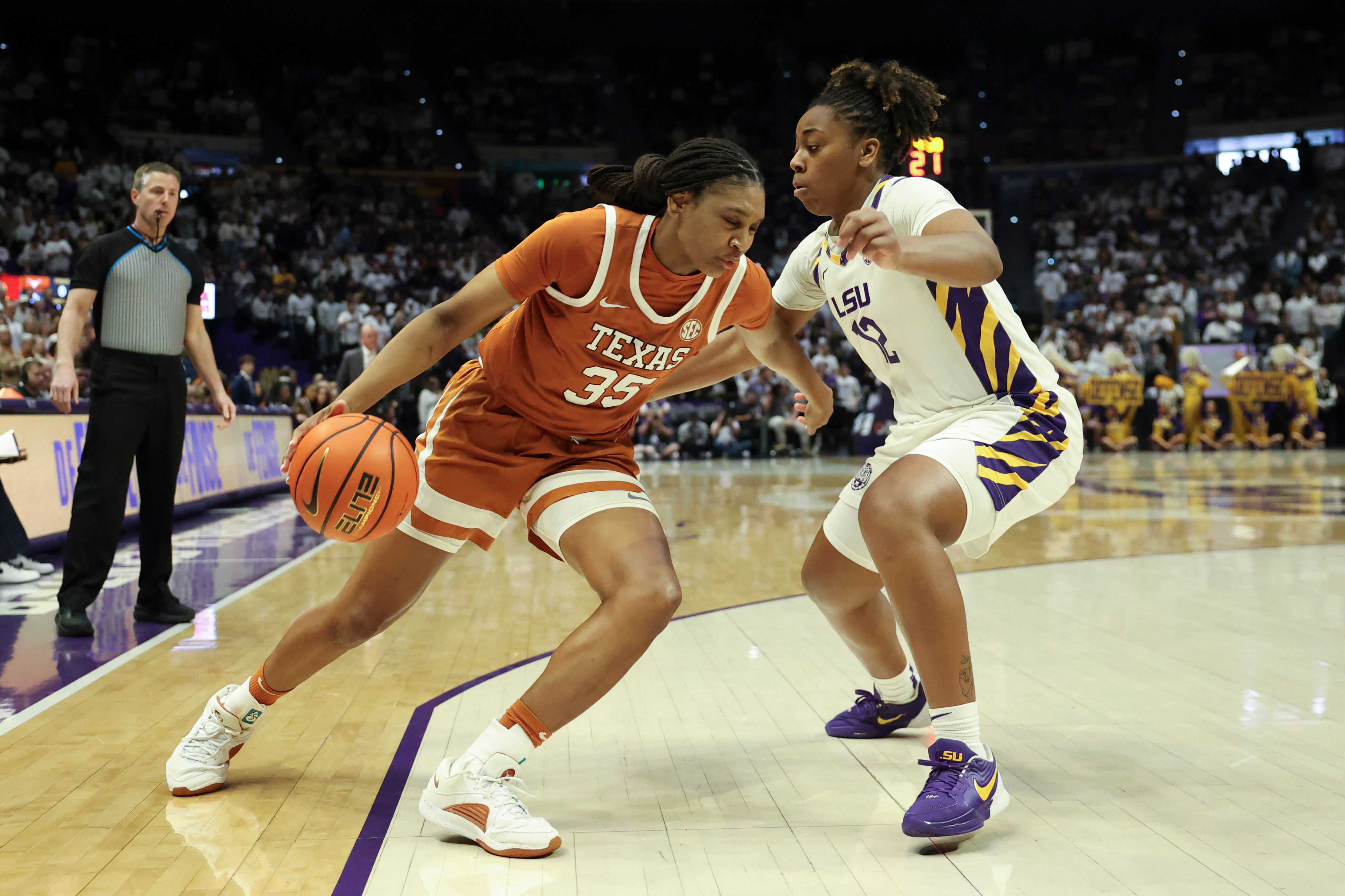 Texas forward Madison Booker (35) tries to drive past LSU guard Mikaylah Williams (12) in the first half of an NCAA college basketball game in Baton Rouge, La., Sunday, Jan. 11, 2026.