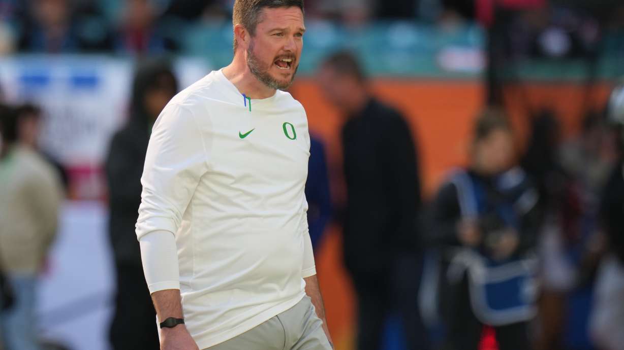 Oregon head coach Dan Lanning watches as players warm up for the Orange Bowl College Football Playoff quarterfinal game against Texas Tech, Thursday, Jan. 1, 2026, in Miami Gardens, Fla.