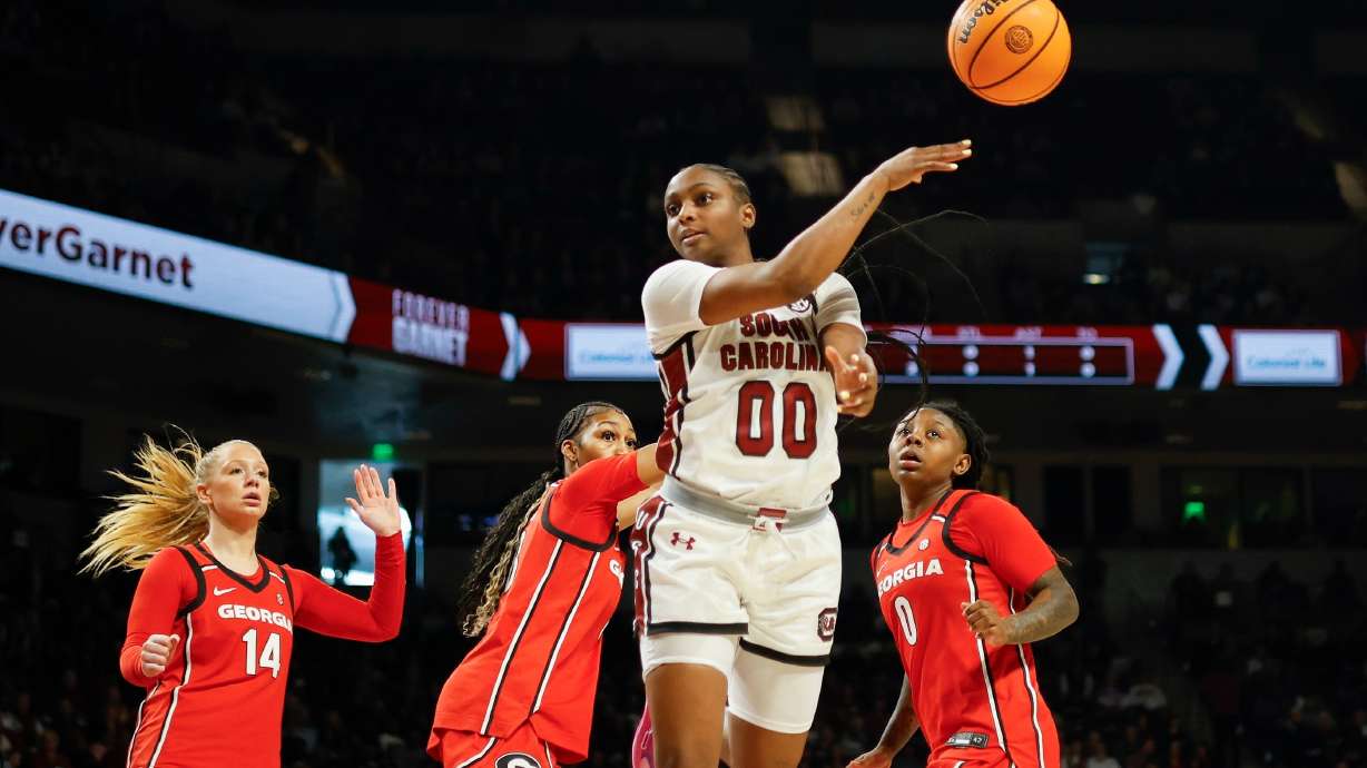 South Carolina guard Ta'Niya Latson (00) passes the ball ahead of Georgia guard Rylie Theuerkauf (14), forward Zhen Craft, second from left, and guard Trinity Turner (0) during the first half of an NCAA college basketball game in Columbia, S.C., Sunday, Jan. 11, 2026.