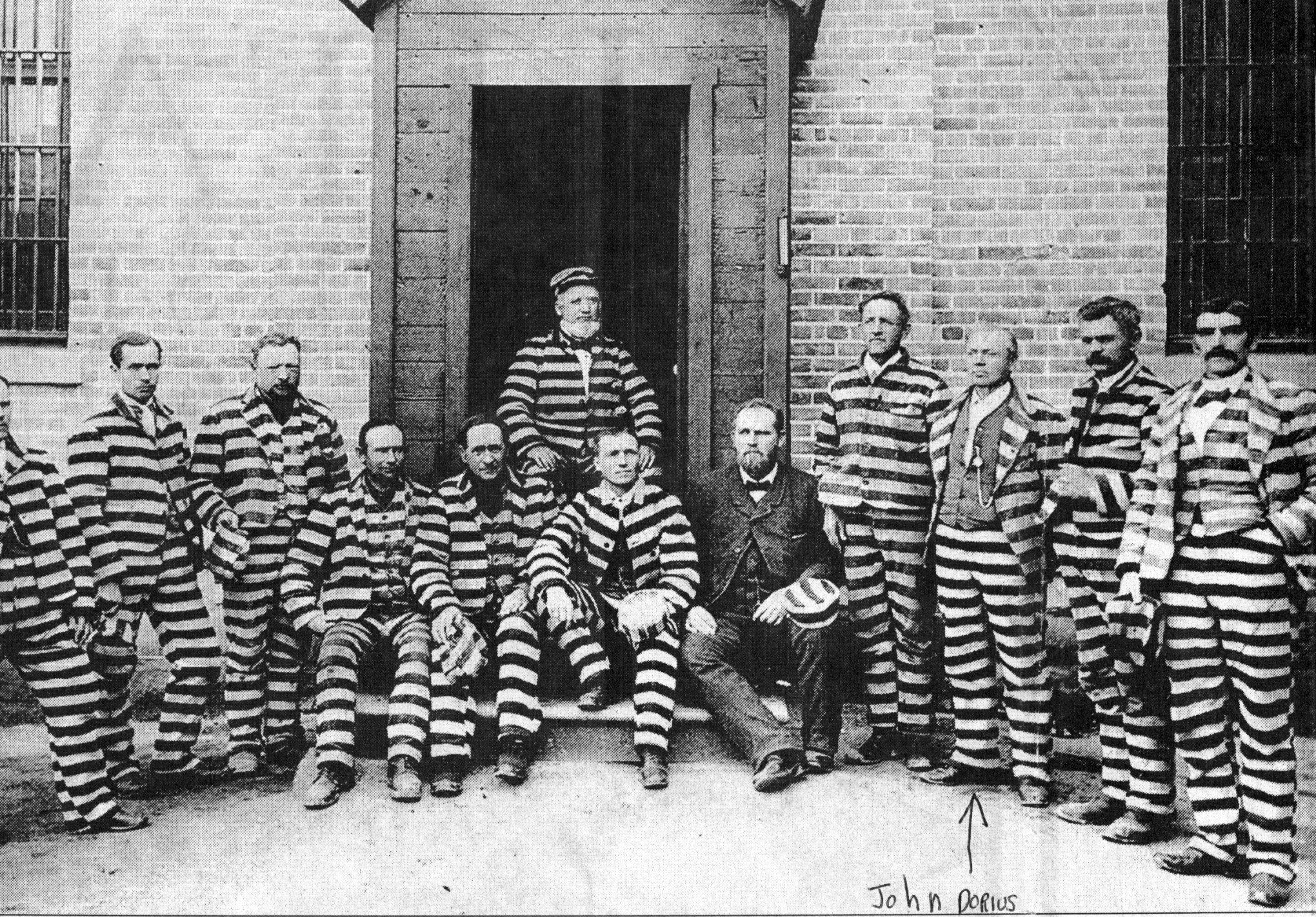 This is a postcard sent from John Dorius (third from the right), to his daughter in 1888. Dorius was imprisoned in the old Utah Penitentiary in Sugar House for polygamy.
