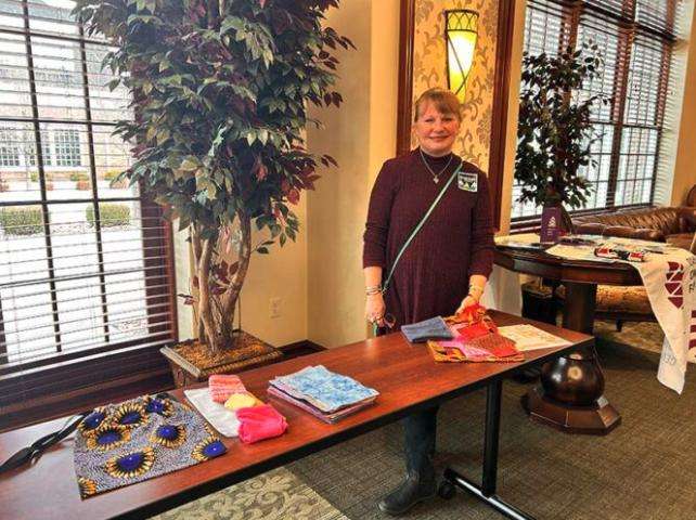 Peggy Jessmore speaks at her table during Saturday’s event at Melaleuca.