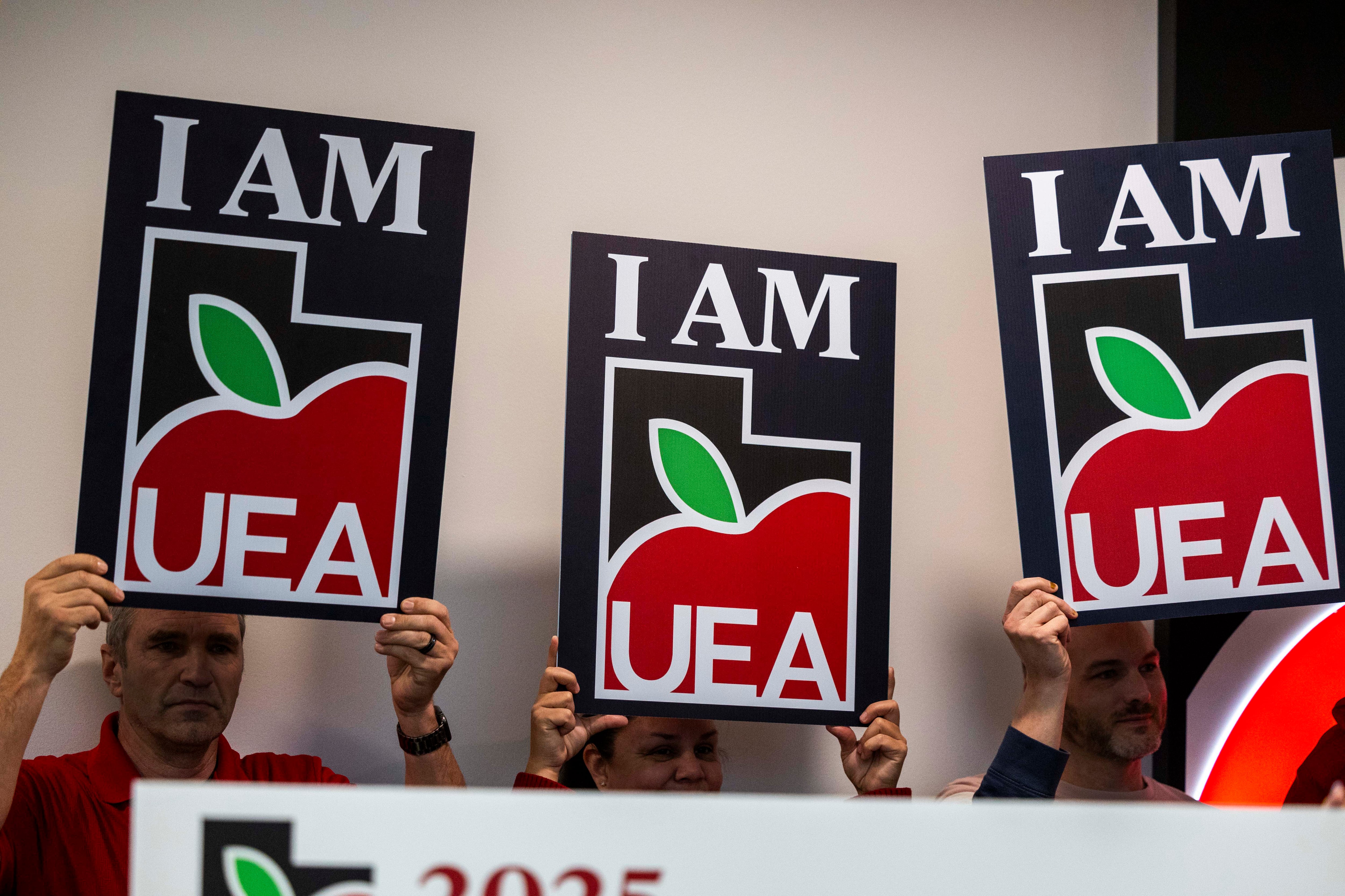 Utah Education Association signs are held up during a press conference at their headquarters in Murray, Jan. 13, 2025. The association is pushing back against a divisive teacher discipline bill that is still sitting on Gov. Spencer Cox's desk as of Tuesday.
