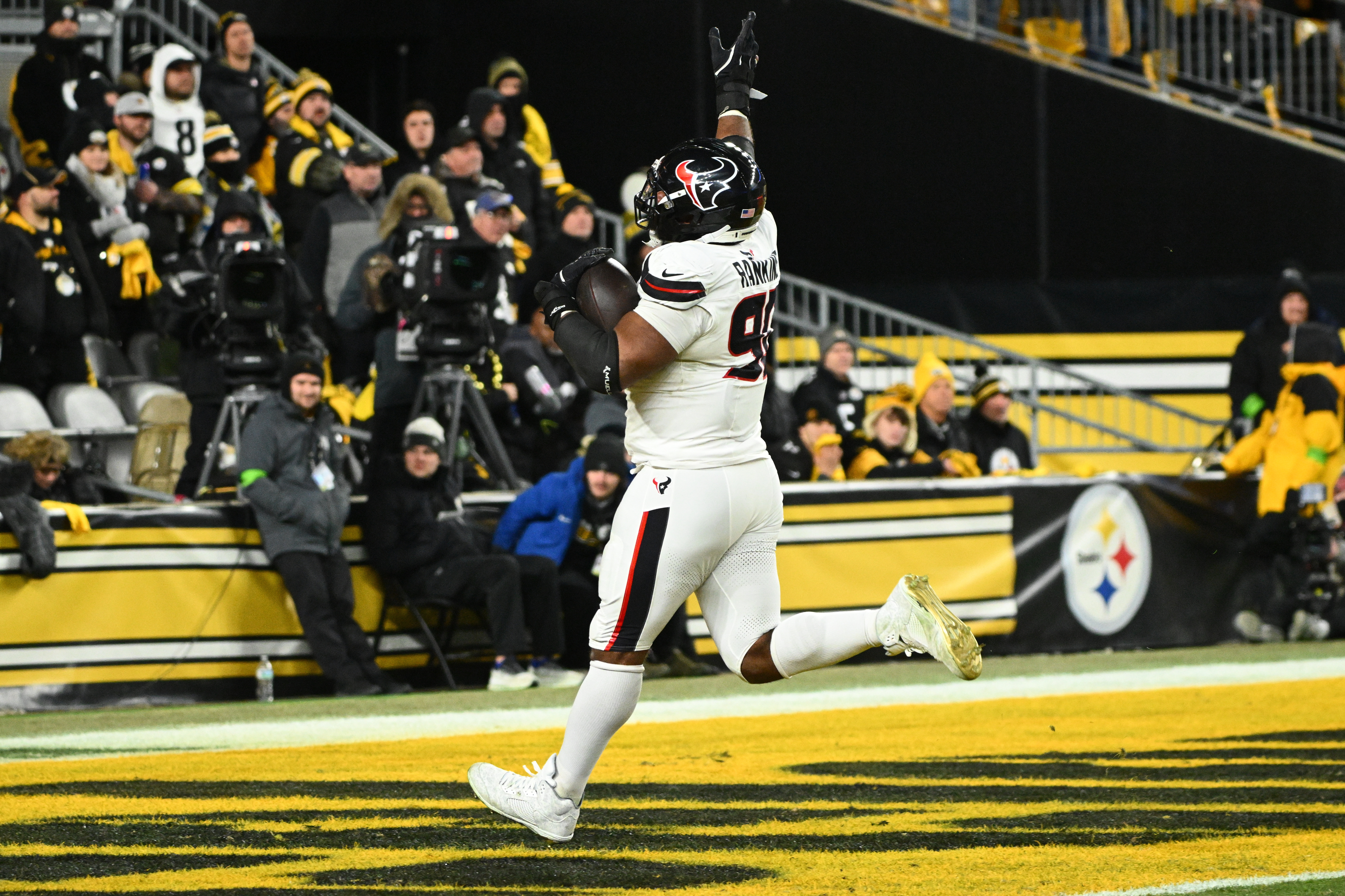 Houston Texans defensive tackle Sheldon Rankins runs to the end zone for a touchdown after recovering a fumble during the second half of an NFL wild-card playoff football game against the Pittsburgh Steelers, Monday, Jan. 12, 2026, in Pittsburgh.