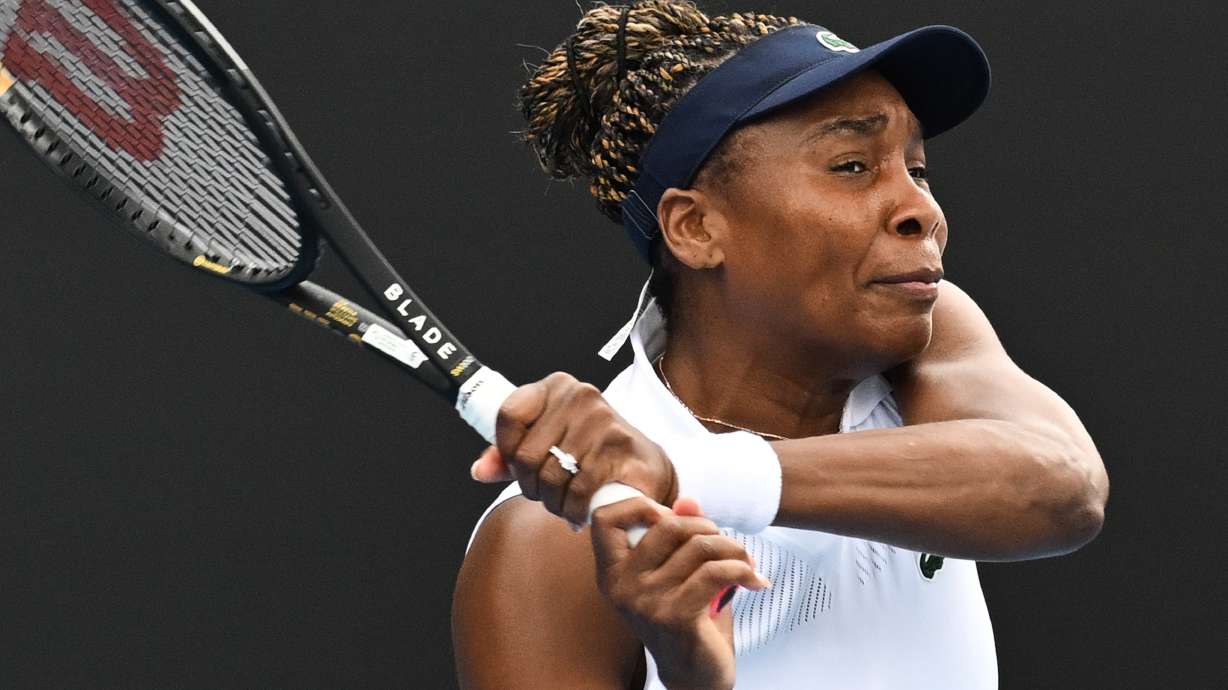 Venus Williams of the U.S. hits a backhand to Magda Linette of Poland during her singles match of the ASB Classic Women's Tennis Tournament in Auckland, New Zealand, Tuesday Jan. 6, 2026.