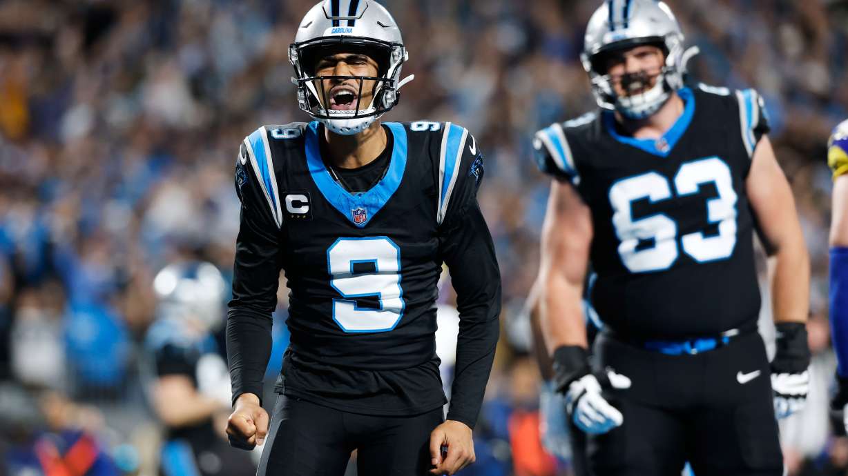 Carolina Panthers quarterback Bryce Young (9) celebrates after scoring a touchdown during the first half of an NFL wild-card playoff football game against the Los Angeles Rams, Saturday, Jan. 10, 2026, in Charlotte, N.C.