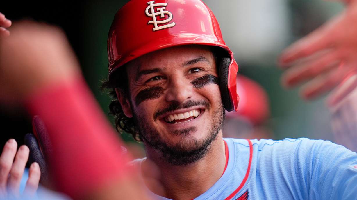 FILE - St. Louis Cardinals' Nolan Arenado celebrates in the dugout after hitting a home run during the fourth inning of a baseball game against the Chicago Cubs, Saturday, Sept. 27, 2025, in Chicago.