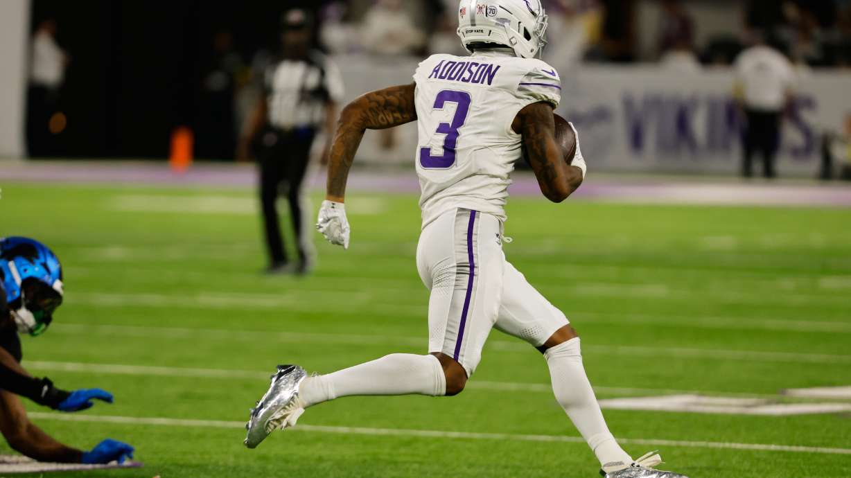 Minnesota Vikings wide receiver Jordan Addison runs to score a touchdown during the second half of an NFL football game against the Detroit Lions, Thursday, Dec. 25, 2025, in Minneapolis.