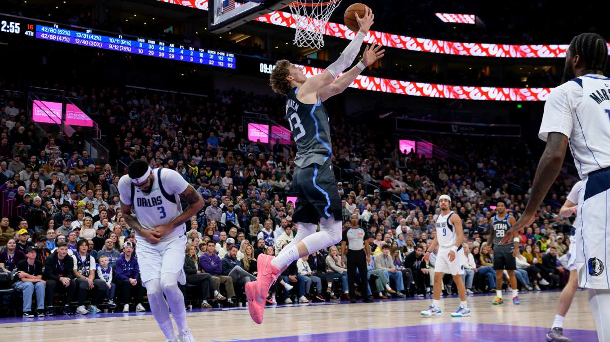 Utah Jazz forward Lauri Markkanen, center, lays the ball to the basket as Dallas Mavericks forward Anthony Davis, left, is injured on the play during the second half of an NBA basketball game against the Dallas Mavericks, Thursday, Jan. 8, 2026, in Salt Lake City.