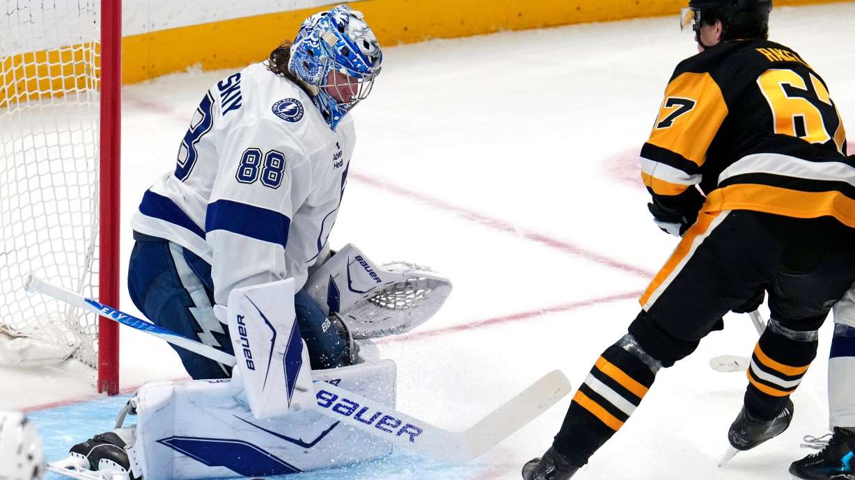 Tampa Bay Lightning goaltender Andrei Vasilevskiy (88) blocks a shot by Pittsburgh Penguins' Rickard Rakell during the first period of an NHL hockey game in Pittsburgh, Tuesday, Jan. 13, 2026.