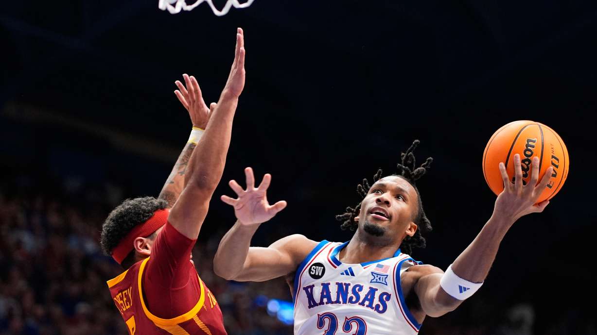 Kansas guard Darryn Peterson (22) shoots over Iowa State forward Joshua Jefferson (5) during the first half of an NCAA college basketball game Tuesday, Jan. 13, 2026, in Lawrence, Kan.