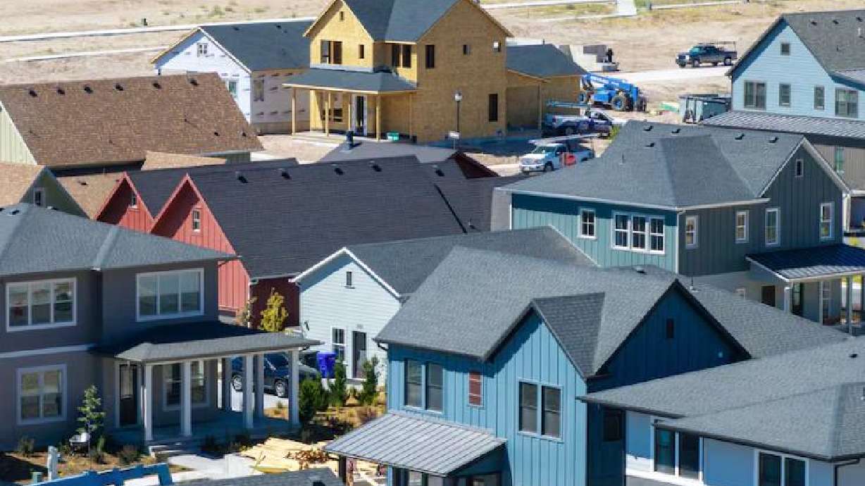 Workers build homes in West Jordan on Aug. 11, 2025. It continues to be difficult and more expensive for people, especially young people, to purchase a home in Utah.