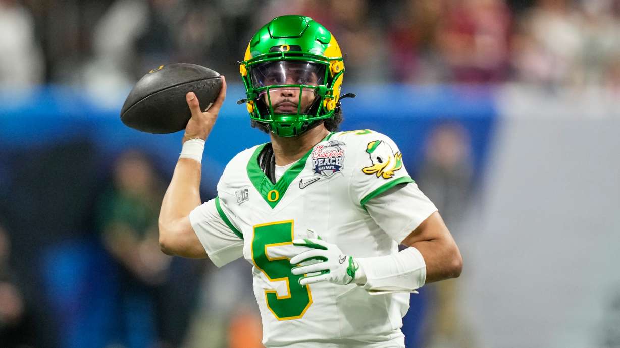 Oregon quarterback Dante Moore (5) passes against Indiana during the second half of the Peach Bowl NCAA college football playoff semifinal, Friday, Jan. 9, 2026, in Atlanta.