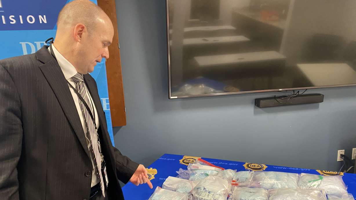 Miguel Chino, assistant special agent in charge of the Rocky Mountain Field Division of the Drug Enforcement Administration, looks over some of the 2 million fentanyl pills seized by his division in Utah in 2025 on Wednesday.