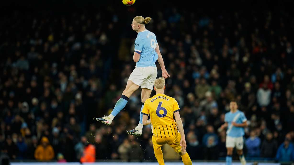 Manchester City's Erling Haaland, top, heads the ball past Brighton's Jan Paul van Hecke during the English Premier League soccer match between Manchester City and Brighton and Hove Albion in Manchester, England, Wednesday, Jan. 7, 2026.