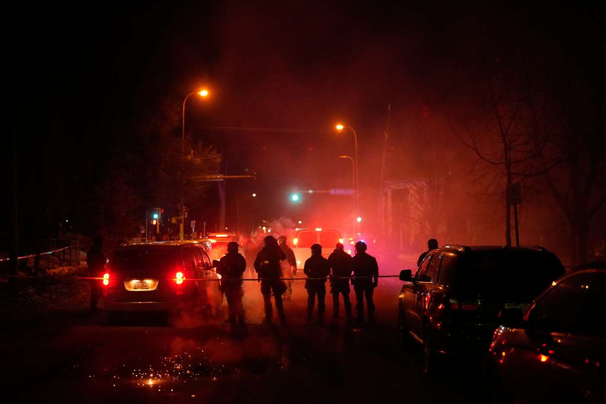 Tear gas surrounds federal law enforcement officers as they leave a scene after a shooting on Wednesday in Minneapolis.