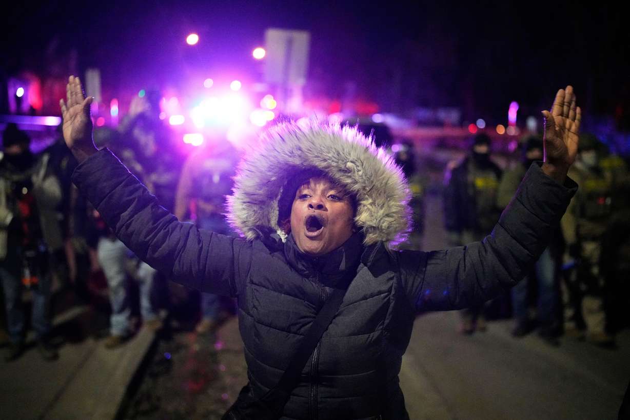 A protester yells in front of law enforcement after a shooting on Wednesday in Minneapolis.