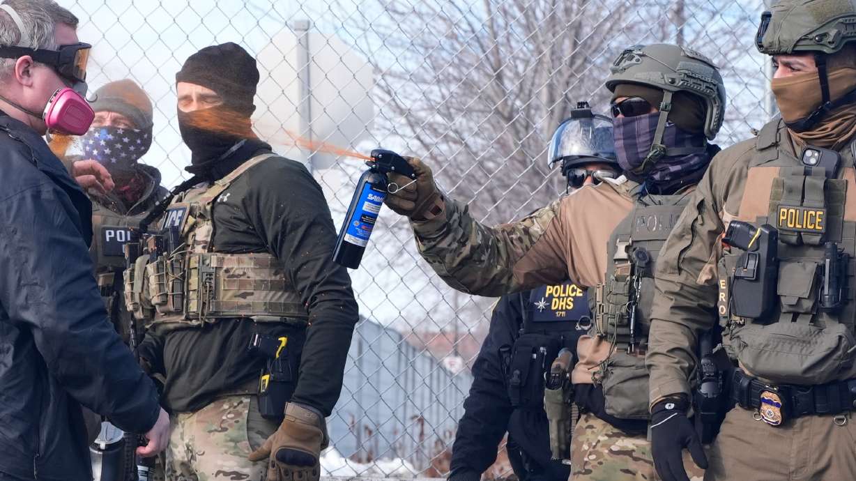 An Immigration and Customs Enforcement agent shoots pepper spray at a protester in Minneapolis, Minnesota, on Jan. 12. A Utah lawmaker has proposed a bill to put a check on immigration enforcement action in the state.