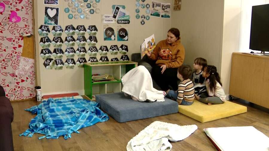 A day care provider in Utah reads to children. State Rep. Jason Thompson is urging the Legislature to address child care this year.