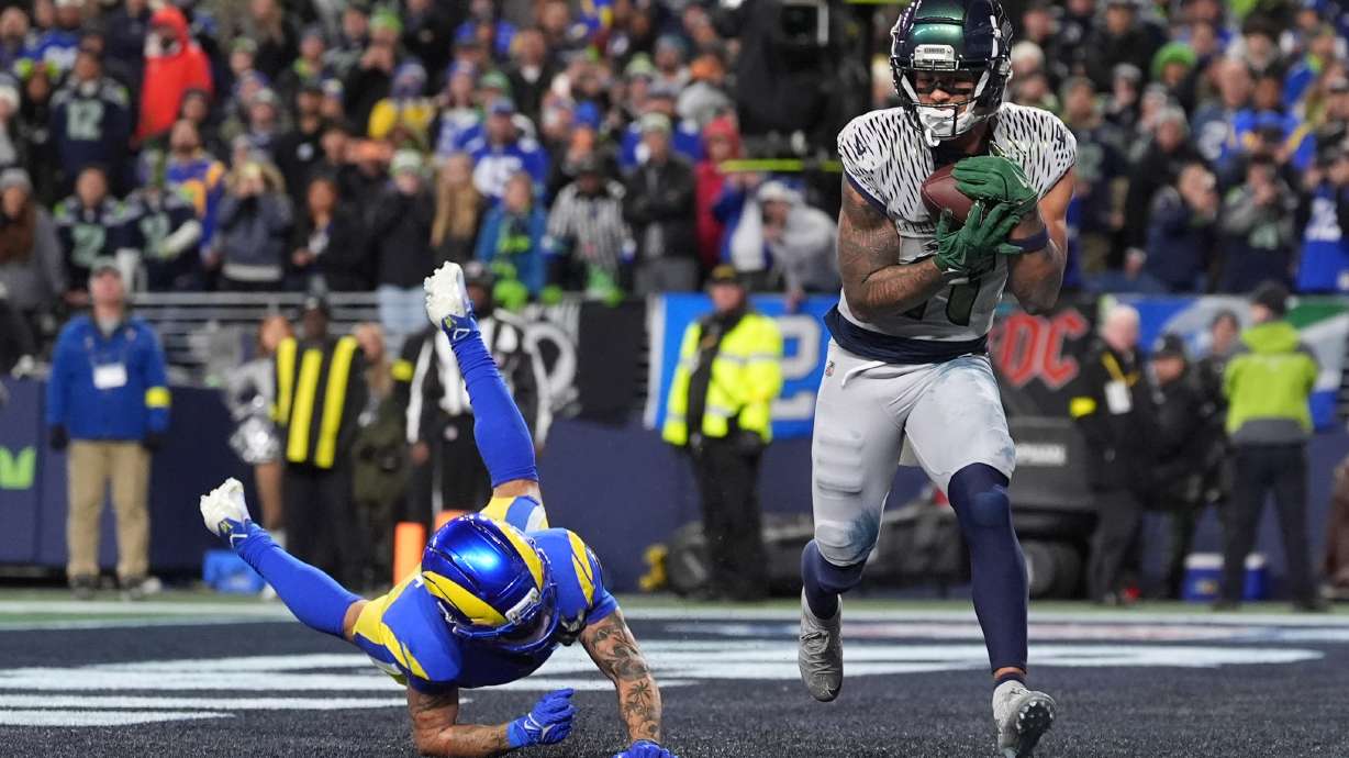 Seattle Seahawks wide receiver Jaxon Smith-Njigba (11) scores a touchdown during overtime in an NFL football game against the Los Angeles Rams, Thursday, Dec. 18, 2025, in Seattle.