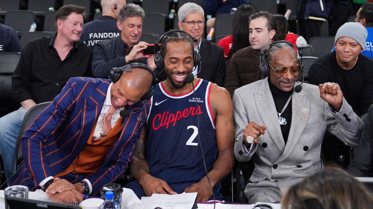 NBA analyst, Snoop Dogg, right, appears with Los Angeles Clippers forward Kawhi Leonard, center, and former NBA player and lead game analyst for NBC Sports, Reggie Miller, following the team's NBA basketball game against the Golden State Warriors, Monday, Jan. 5, 2026, in Inglewood, Calif.