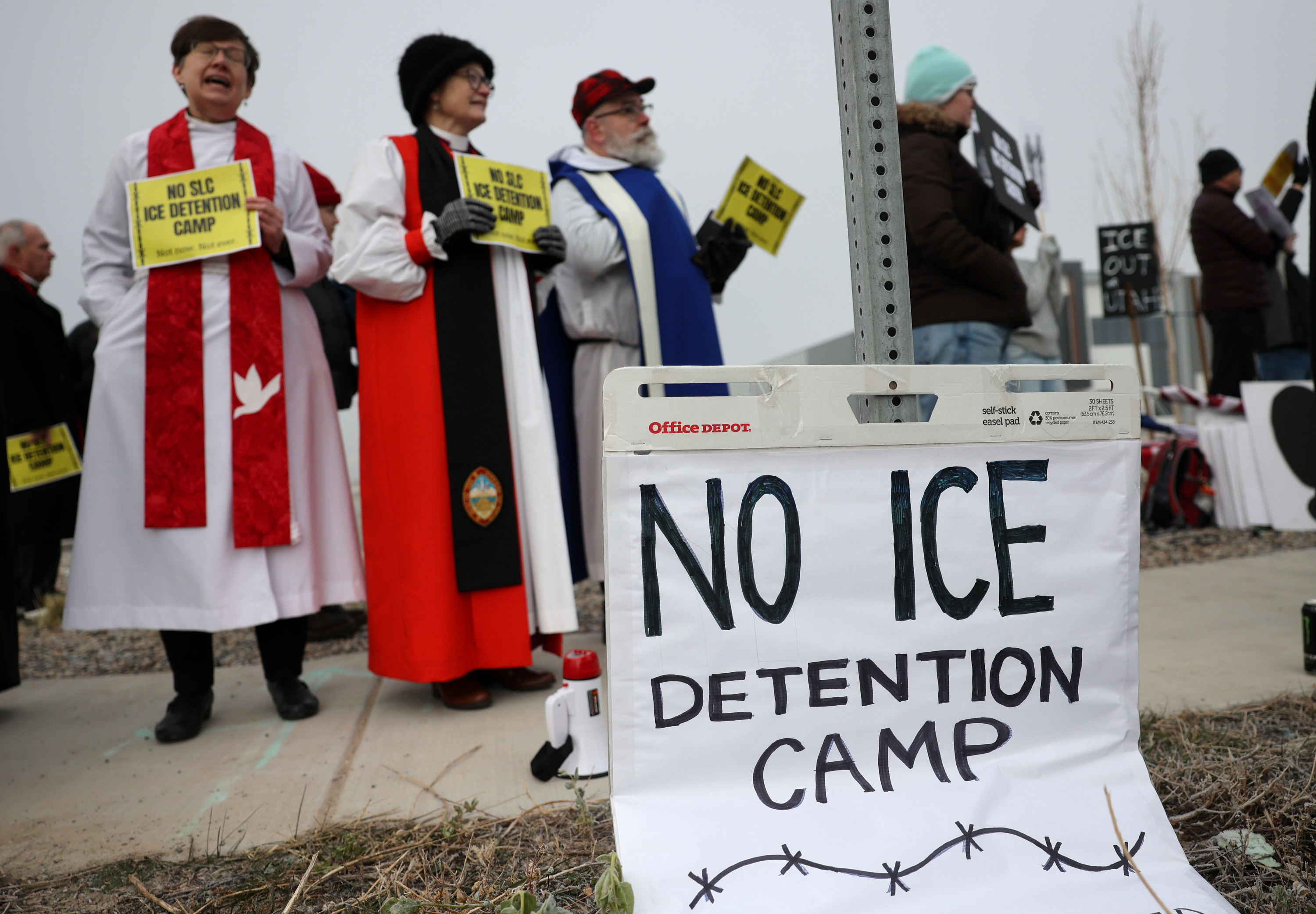 Around 100 people protested Immigration and Customs Enforcement outside a potential future ICE detention center site in Salt Lake City on Friday.