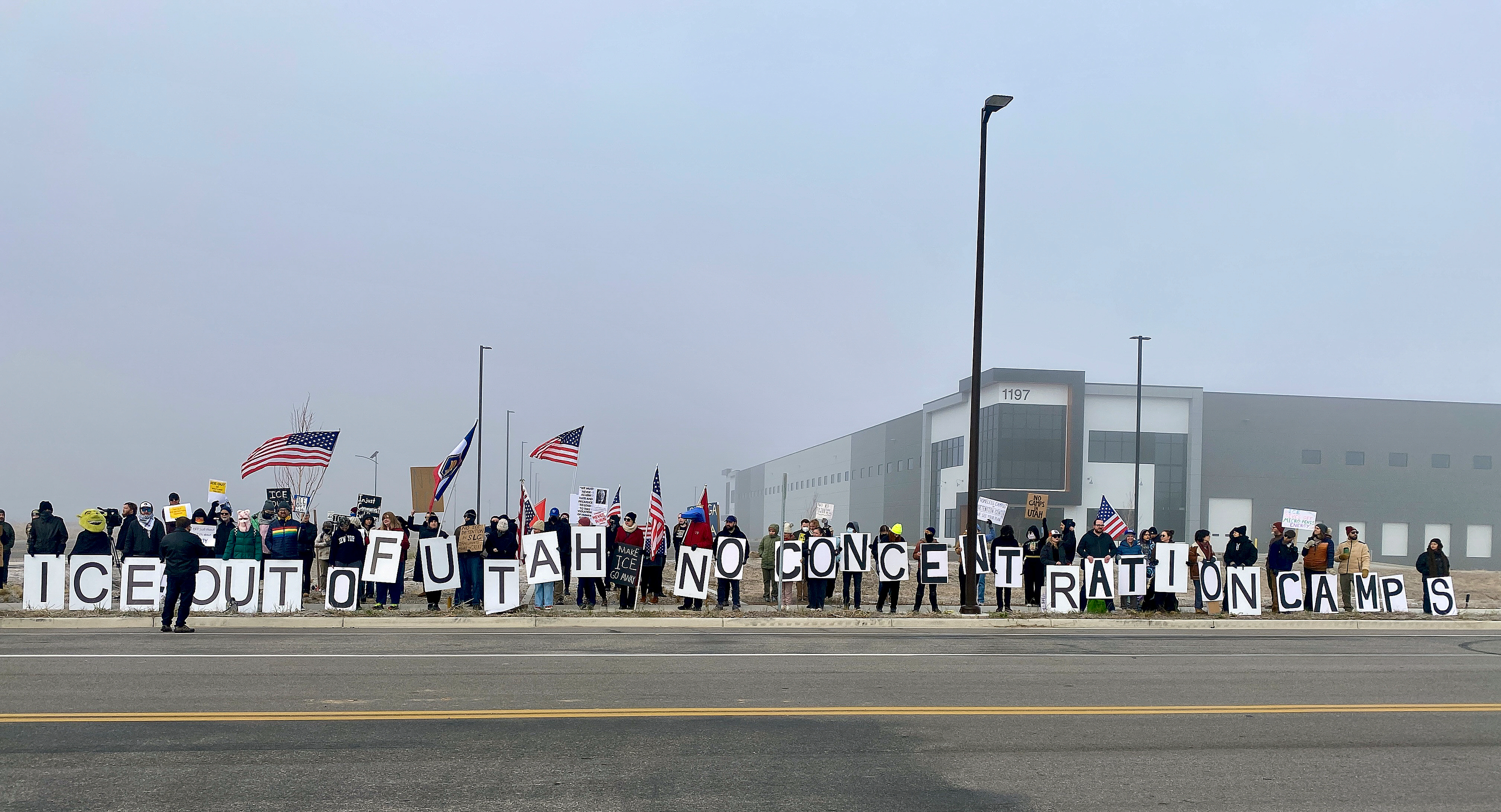Around 100 people protested Immigration and Customs Enforcement outside a potential future ICE detention center site in Salt Lake City on Friday.