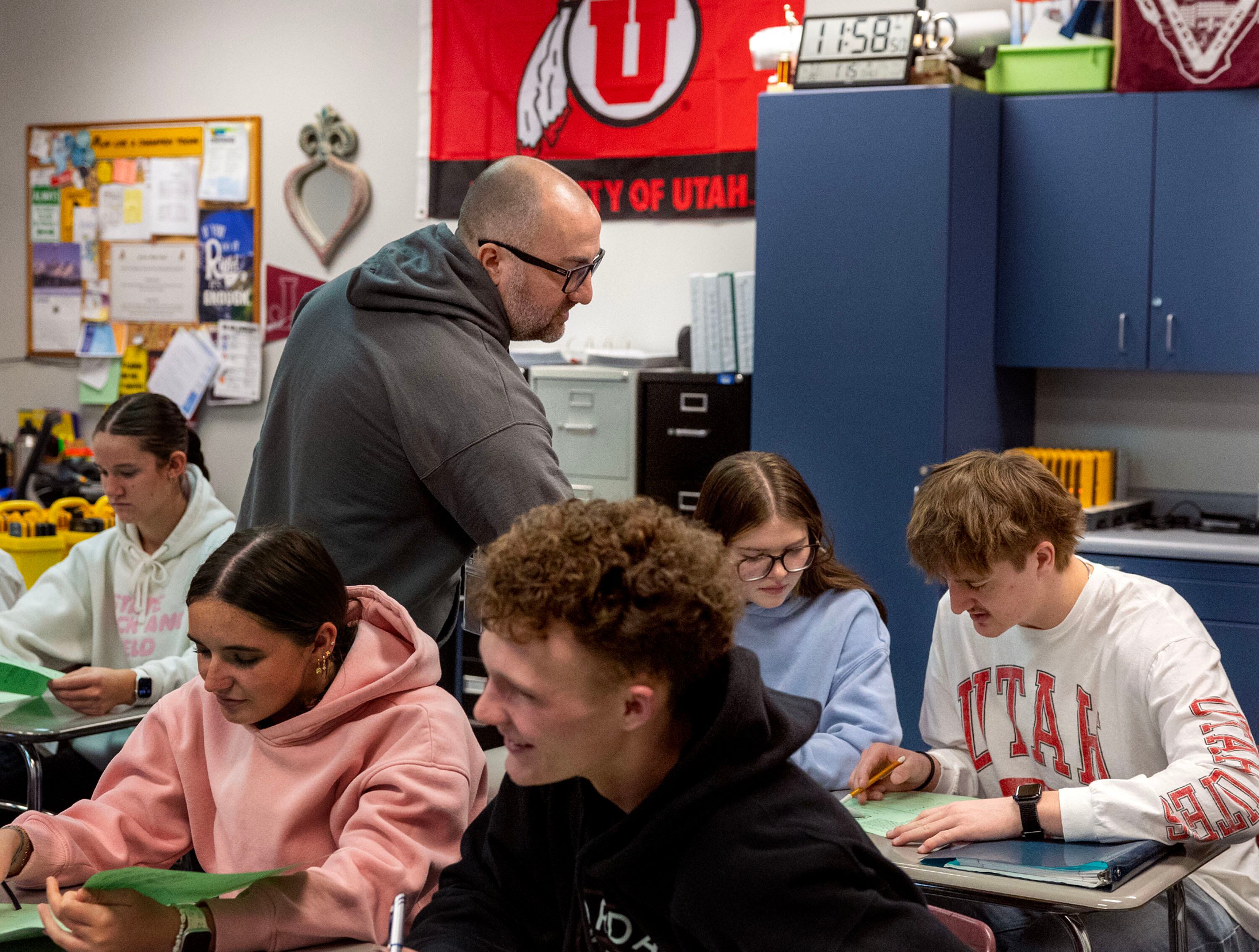 Peter Newbold helps students in his Math 1030 class, a concurrent enrollment class, at Jordan High School in Sandy on Thursday. Concurrent enrollment numbers are at record highs, according to the Utah State Board of Education.