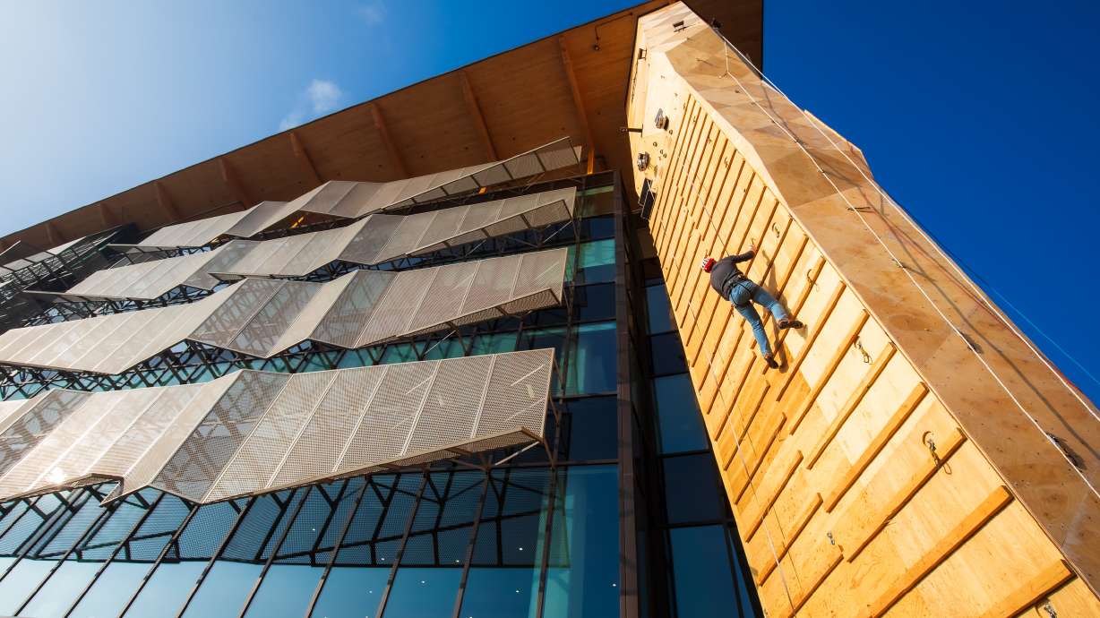 Lex Border, a U.S. competitive climber based in Utah, tests out Millcreek's new dry-tooling wall that is part of Millcreek Common on Friday. The wall will be available for public climbing on Fridays and Saturdays beginning on Saturday.