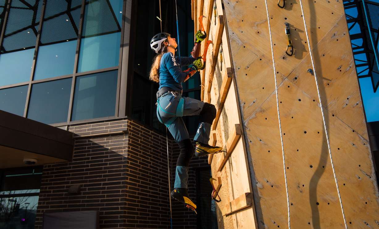 Alex Rudow, a Millcreek resident and member of the U.S. Ice Climbing Team, begins climbing dry-tooling wall outside of Millcreek Common on Friday. Rudow suggested the idea of converting the 65-foot climbing wall into a dry-tooling feature.