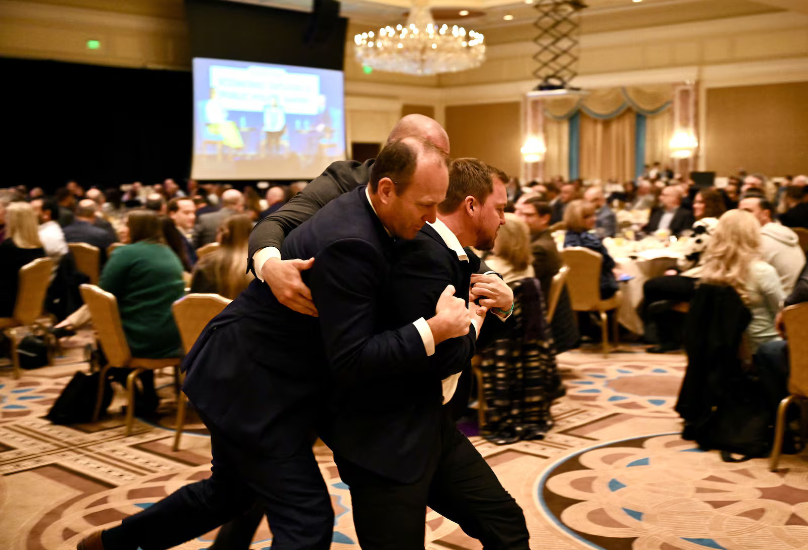 A protester is removed by security after heckling former Arizona Sen. Kyrsten Sinema during the 2026 Utah Economic Outlook & Public Policy Summit on Friday at the Grand America in Salt Lake City, Friday.