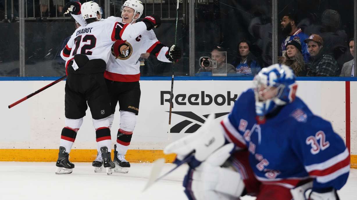 Ottawa Senators' Brady Tkachuk, center, celebrates with teammate Thomas Chabot, left, after scoring a goal as New York Rangers goaltender Jonathan Quick (32) looks away during the first period of an NHL hockey game Wednesday, Jan. 14, 2026, in New York.