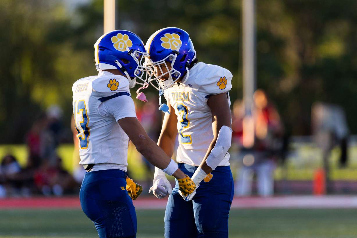 Orem’s Kaue Akana and Roger Saleapaga celebrate during their high school football season opener against East at East High School in Salt Lake City on Friday, Aug. 11, 2023. Orem won the game 21-20.