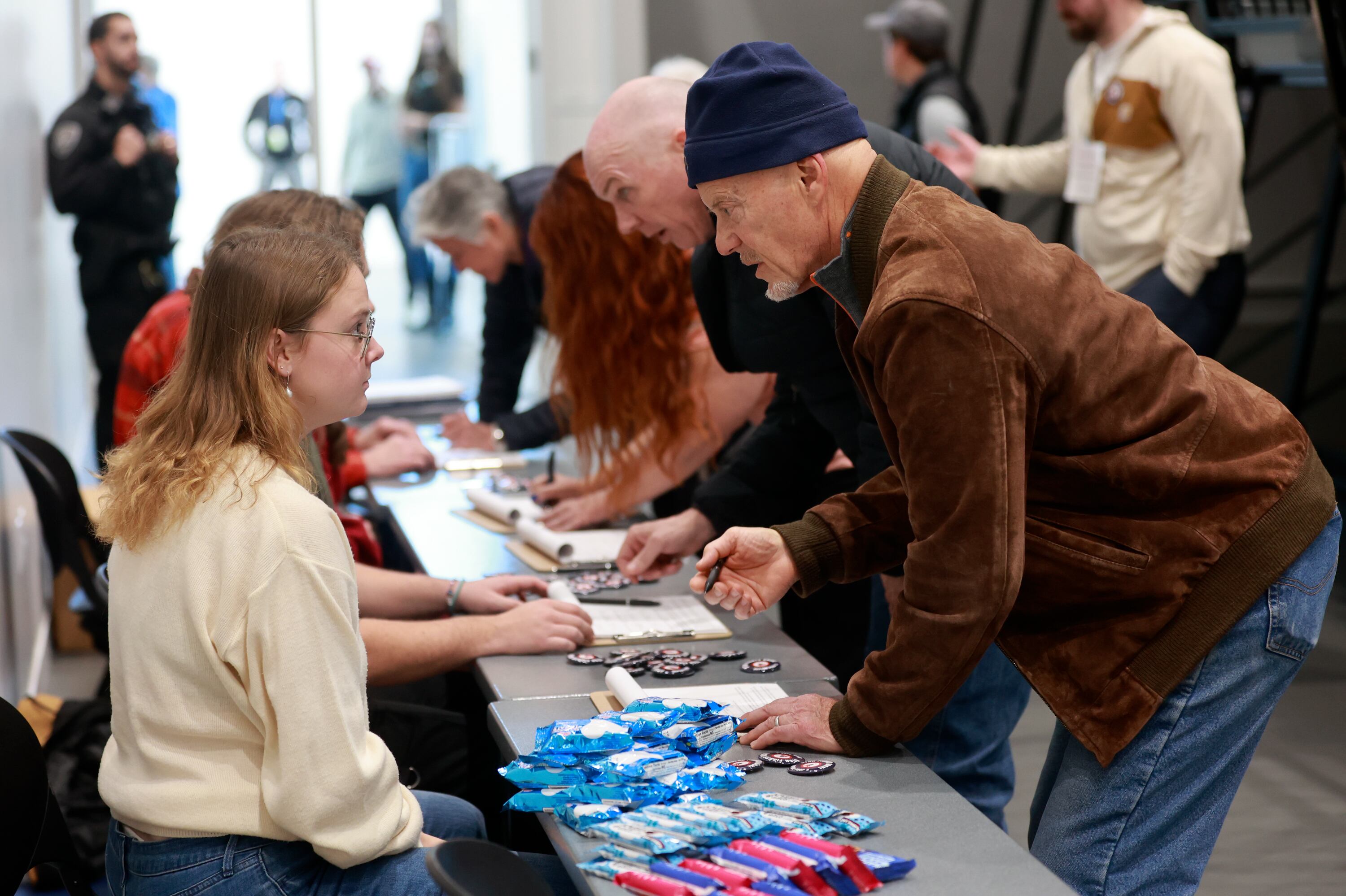 Berkley Scharmann, Weber State College Republicans executive director, helps Paul Lit sign to repeal Proposition 4 at the Weber County Fights Back Rally with Scott Presler at the Roy Library in Roy on Friday, Jan. 16, 2026.