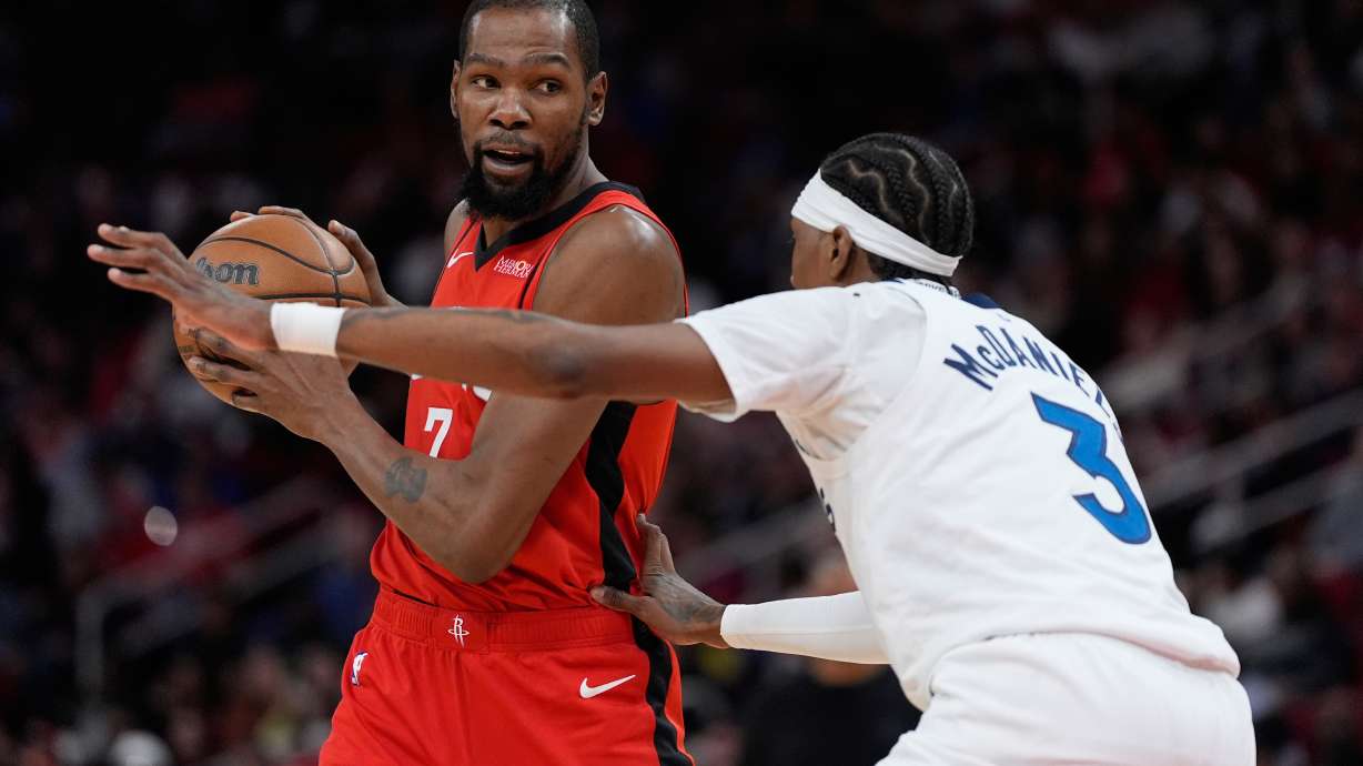 Minnesota Timberwolves forward Jaden McDaniels (3) defends against Houston Rockets forward Kevin Durant (7) during the first half of an NBA basketball game in Houston, Friday, Jan. 16, 2026.