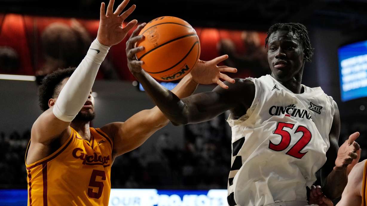 Iowa State Cyclones Joshua Jefferson (5) and Cincinnati center Moustapha Thiam (52) battle for a rebound during the first half of an NCAA college basketball game, Saturday, Jan. 17, 2026, in Cincinnati.