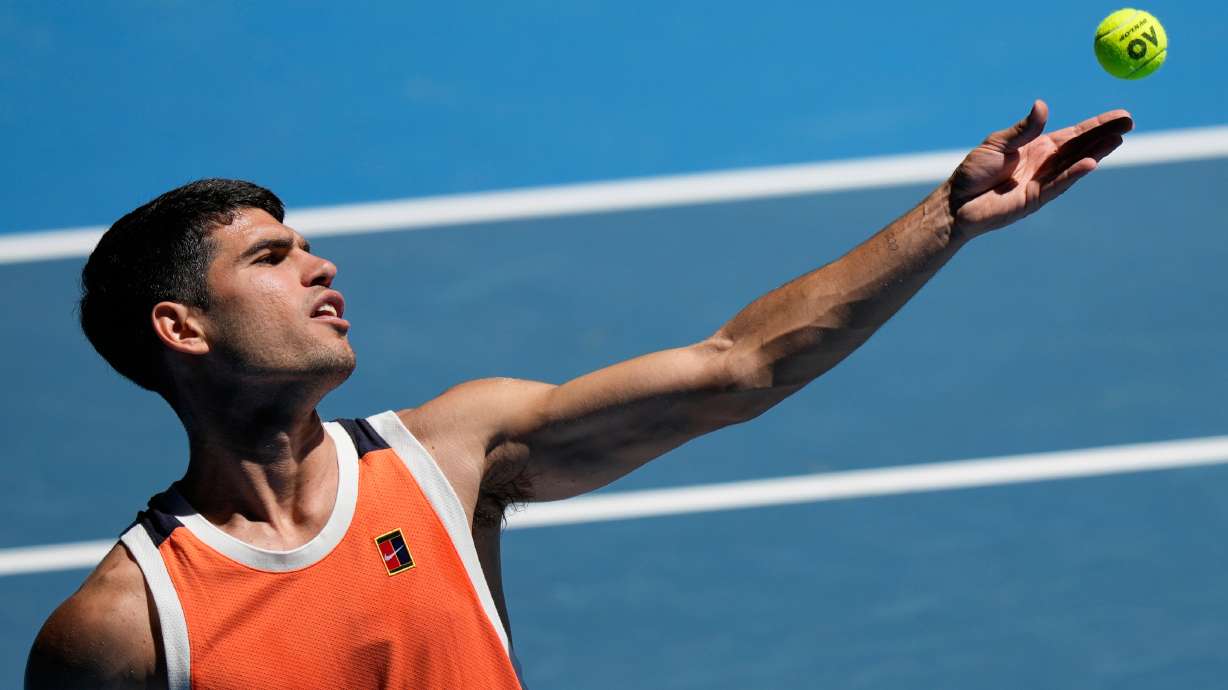 Carlos Alcaraz of Spain serves during a practice session ahead of the Australian Open tennis championship in Melbourne, Australia, Saturday, Jan. 17, 2026.
