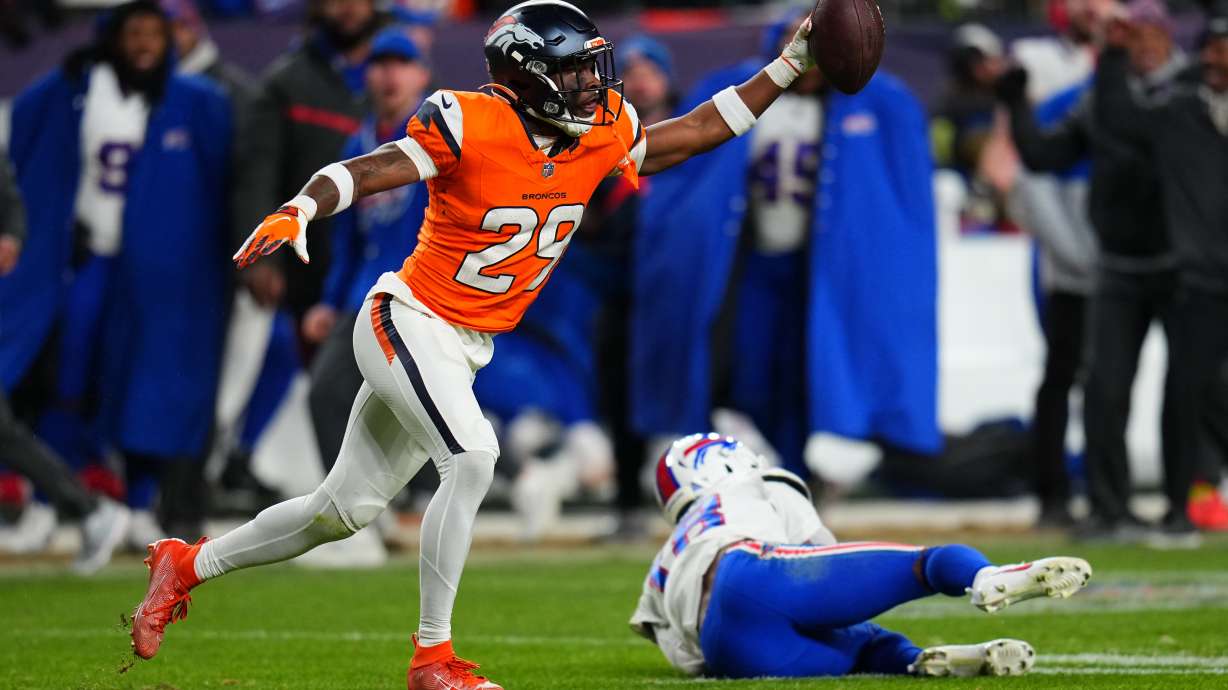 Denver Broncos cornerback Ja'quan McMillian (29) reacts after intercepting a pass intended for Buffalo Bills wide receiver Brandin Cooks (18) during overtime of an NFL divisional round playoff football game, Saturday, Jan. 17, 2026, in Denver.