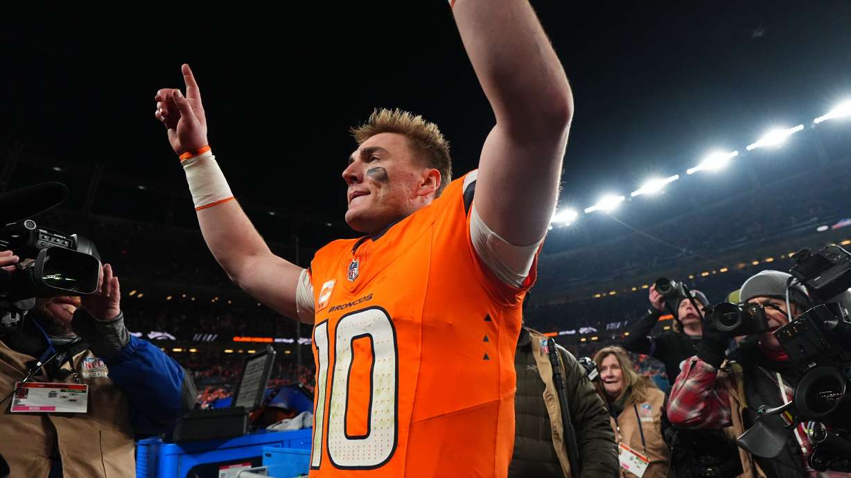 Denver Broncos quarterback Bo Nix celebrates after an NFL divisional round playoff football game against the Buffalo Bills, Saturday, Jan. 17, 2026, in Denver.