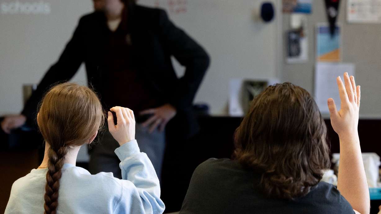 Students raise their hand during class at Jordan High School in Sandy on Jan. 15.