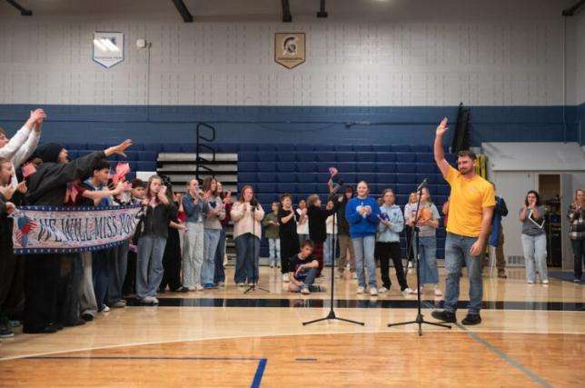 Sean Steo waves to students during a surprise send-off as he’s soon joining the U.S. Navy.