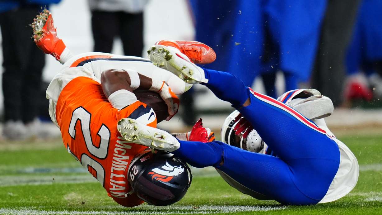Denver Broncos cornerback Ja'quan McMillian (29) intercepts a pass intended for Buffalo Bills wide receiver Brandin Cooks (18) during overtime of an NFL divisional round playoff football game, Saturday, Jan. 17, 2026, in Denver.