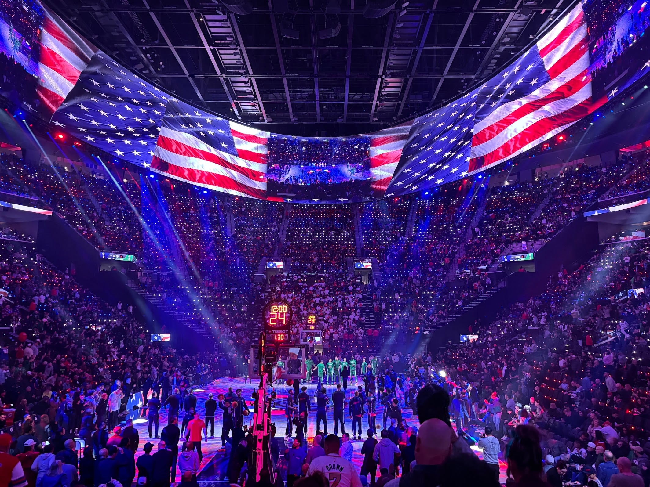 Players and fans come to attention prior to an NBA game between the Los Angeles Clippers and Boston Celtics on Jan. 3. The halo board at the Intuit Dome is the largest video screen in the world.