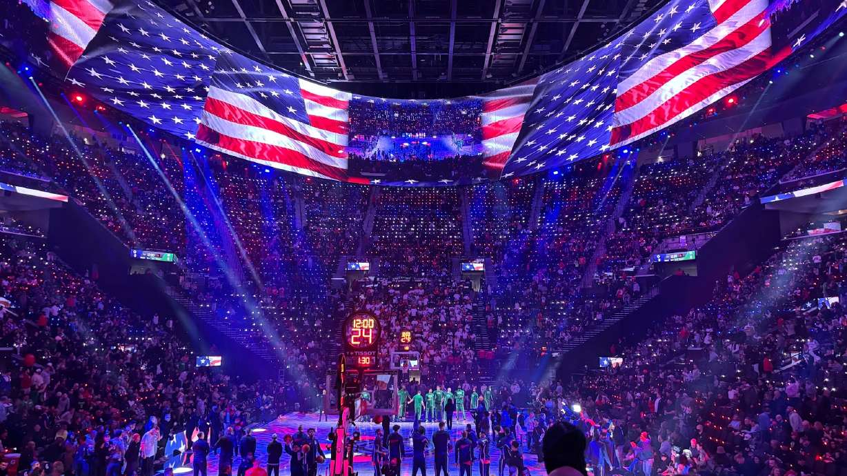 Players and fans come to attention prior to an NBA game between the Los Angeles Clippers and Boston Celtics on Jan. 3. The halo board at the Intuit Dome is the largest video screen in the world.