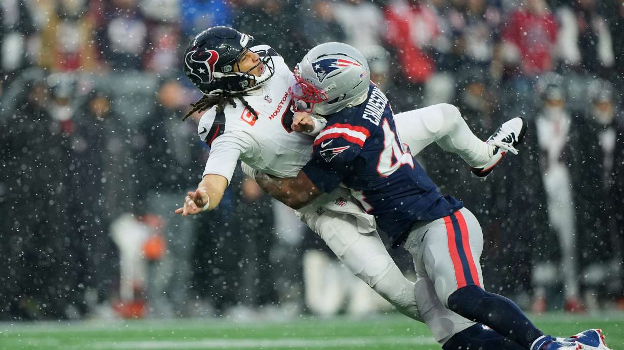 New England Patriots linebacker K'lavon Chaisson, right, hits Houston Texans quarterback C.J. Stroud during the first half of an NFL divisional playoff football game, Sunday, Jan. 18, 2026, in Foxborough, Mass.