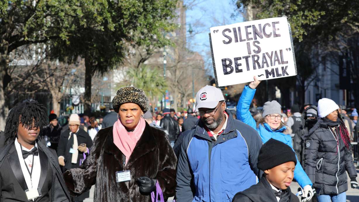 A marcher holds up a sign at a march and rally at the South Carolina Statehouse to honor Martin Luther King Jr. on his holiday on Monday in Columbia, S.C.