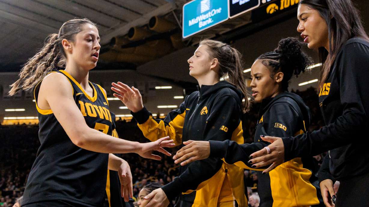 Iowa guard Addison Deal, left, high fives teammates during a Big Ten conference NCAA college basketball game against Oregon in Iowa City, Iowa, Thursday, Jan. 15, 2026.