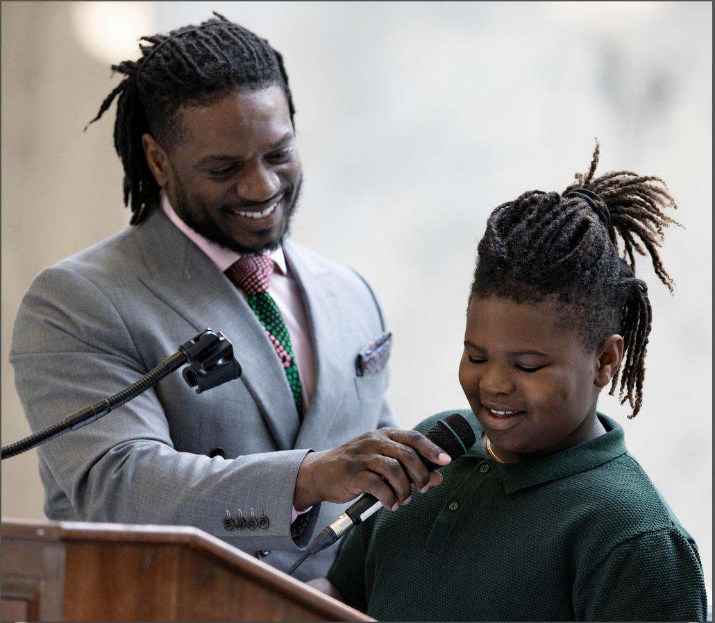 Yahosh Bonner, of American Fork, smiles as his son Nehemiah, 9, helps him recite Martin Luther King Jr.’s “I have a Dream” speech during a Martin Luther King Jr. Day Celebration hosted by Beloved Community at the Capitol in Salt Lake City on Monday.